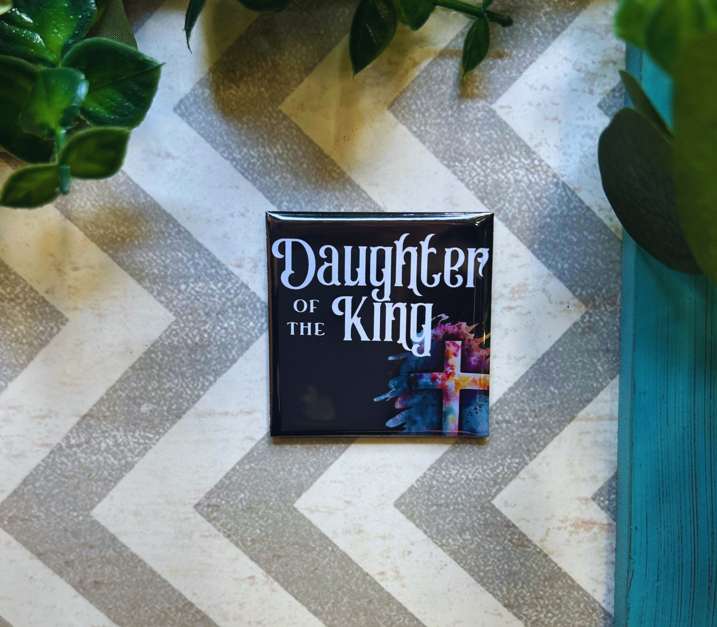 Scripture design drop refrigerator magnet with 'Daughter of the King' text. 